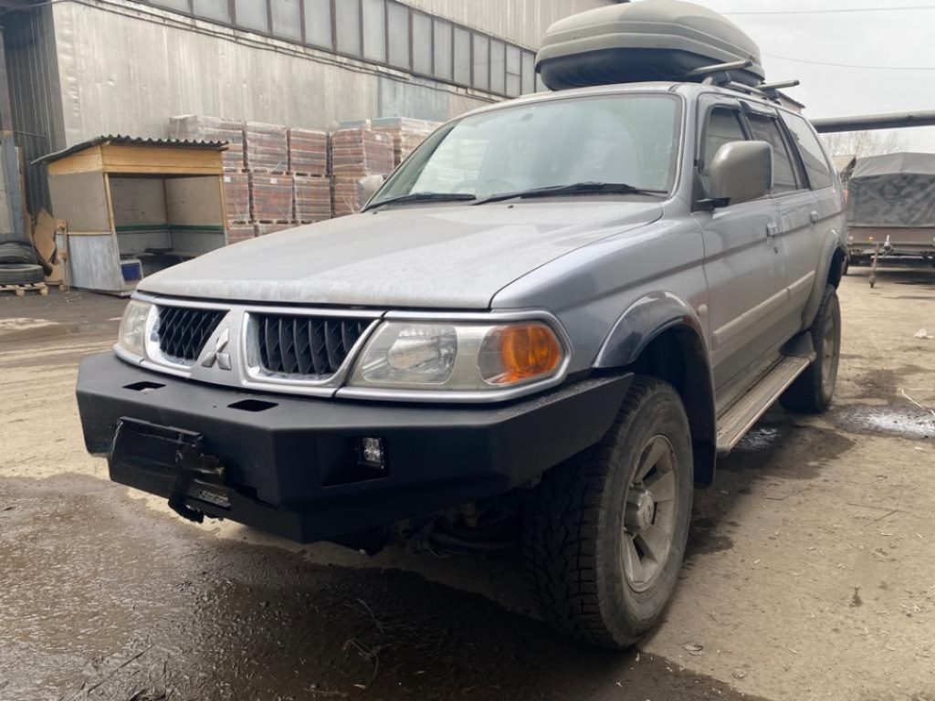 Бампер передний Mitsubishi Pajero Sport 1996-2008 под ПТФ Бампер передний Mitsubishi Pajero Sport 1996-2008 под ПТФ